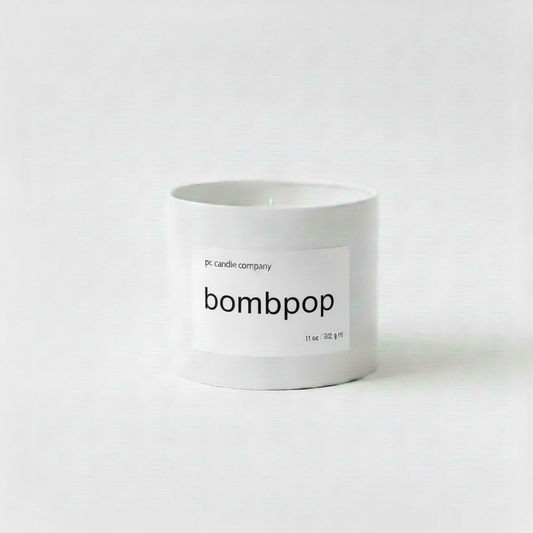 White candle tin with bombpop label