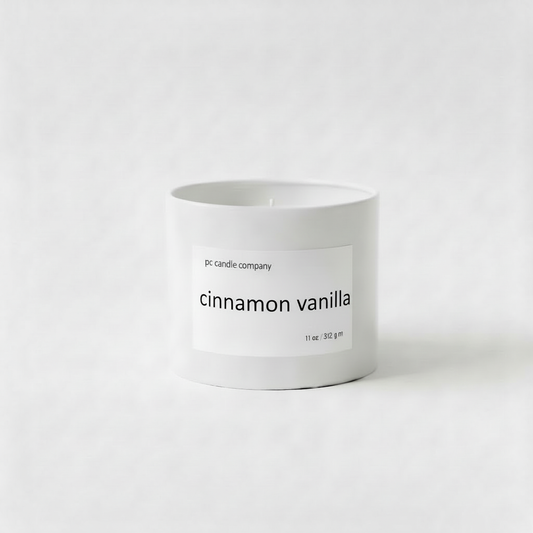 White candle tin with cinnamon vanilla label