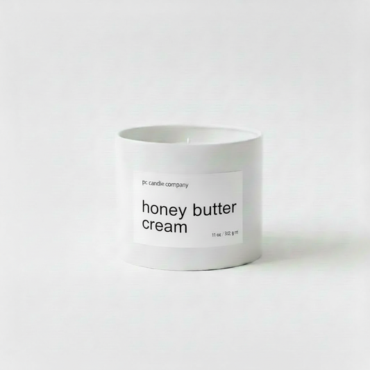White candle tin with honey butter cream label
