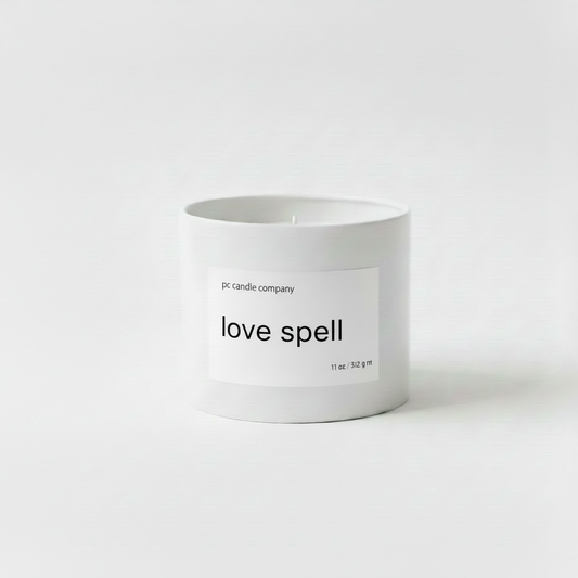 White candle tin with love spell label